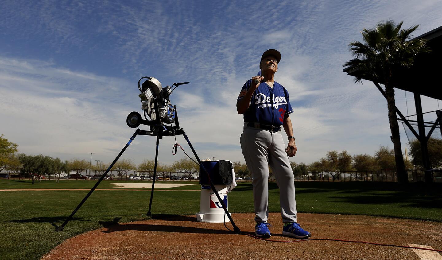 Former Dodgers shortstop Maury Wills gives instruction during a bunting drill at spring training in Glendale, Ariz.