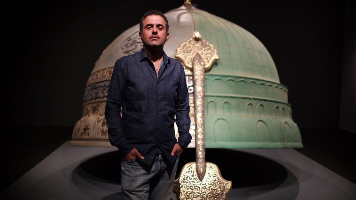 The artist Abdulnasser Gharem in front of "Hemisphere" at the Los Angeles County Museum of Art. His exhibition, "Pause," features work in response to the Sept. 11 terrorist attacks.