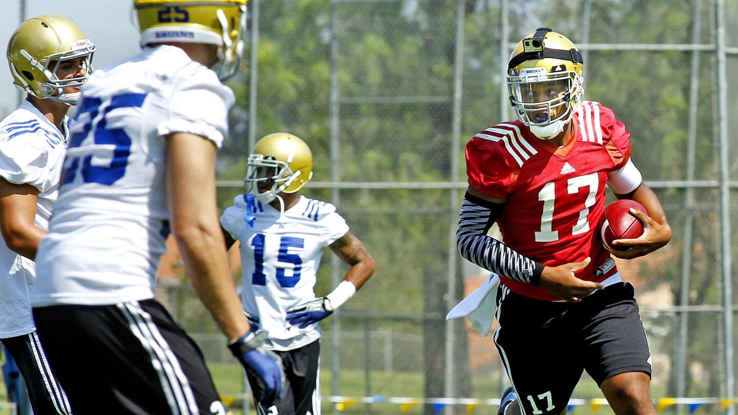 UCLA quarterback Brett Hundley runs through a drill during a team practice session at Cal State San Bernardino on Monday.