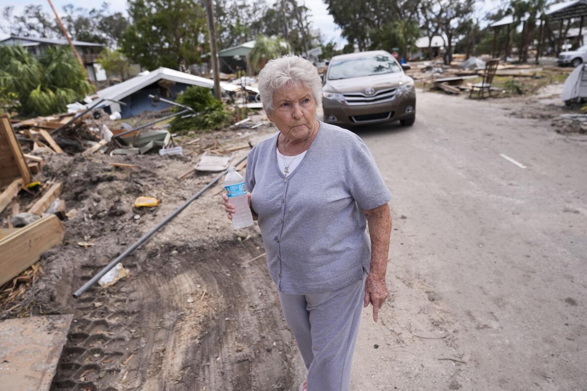 Elsie Hicks looks at the destruction of her home in the aftermath of Hurricane Helene, in Horseshoe Beach, Fla.