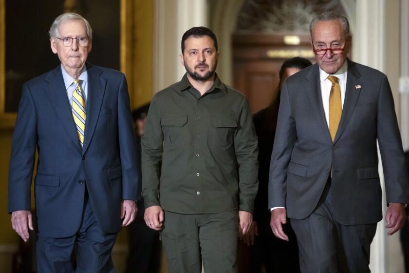 FILE - Ukrainian President Volodymyr Zelenskyy, center, walks with Senate Minority Leader Mitch McConnell of Ky., left, and Senate Majority Leader Chuck Schumer of N.Y., right, at Capitol Hill on Thursday, Sept. 21, 2023, in Washington. (AP Photo/Mark Schiefelbein, File)