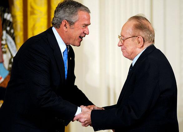 (FILES) US President George W. Bush (L) shakes hands with guitar pioneer Les Paul before presenting him with the 2007 National Medal of Arts, 15 November 2007, in the East Room of the White House in Washington, DC. Les Paul, the guitarist and inventor who changed the course of music with the electric guitar and multitrack recording died at age 94 of complications of pneumonia on August 13, 2009 in New York.