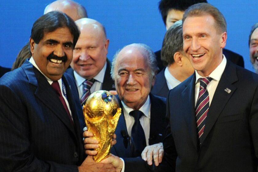 Qatar Football Assn. President Sheikh Hamad bin Khalifa Al-Thani, left, FIFA President Sepp Blatter, center, and Russia Deputy Prime Minister Igor Shuvalov pose with the World Cup trophy after Russia and Qatar were named the 2018 and 2022 World Cup hosts, respectively, in December 2010.