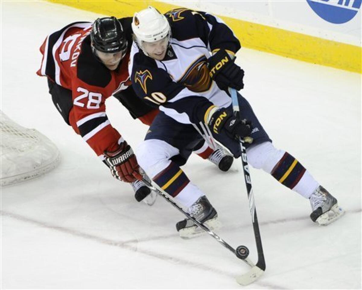 Atlanta Thrashers' Dustin Byfuglien, right, checks New Jersey Devils' Rod  Pelley to the ice during the first period of an NHL hockey game Friday,  Dec. 31, 2010 in Newark, N.J. (AP Photo/Bill