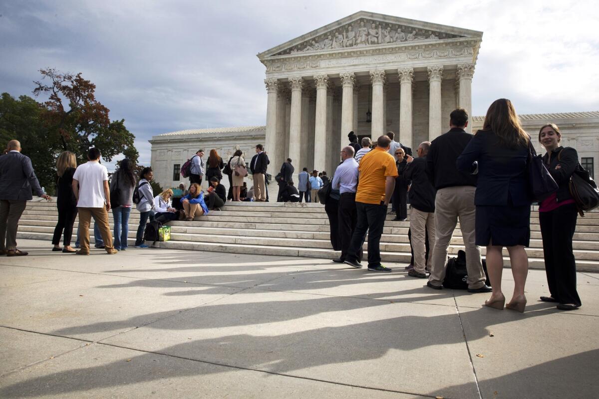 Visitors line up outside of the Supreme Court on Oct. 13, 2015, as the justices begin discussing prisoners who were sentenced as juveniles to life without parole. The court has repeatedly limited such sentences and is set to consider further limits in the Mississippi case of a 15-year-old killer.