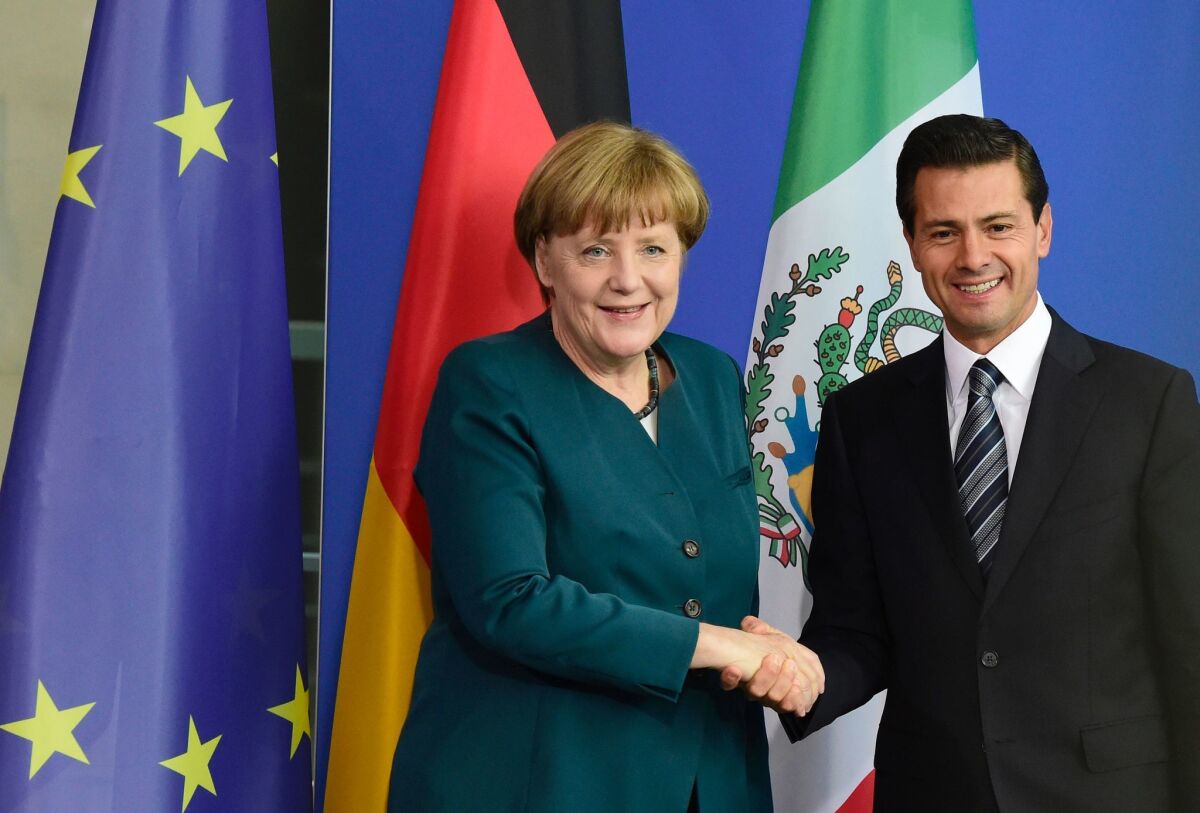German Chancellor Angela Merkel and Mexican President Enrique Peña Nieto shake hands after talks in Berlin in 2016.
