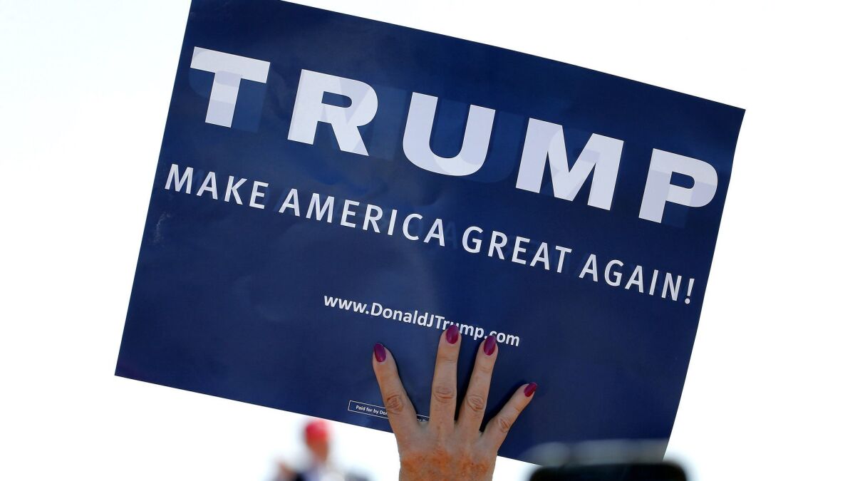 A supporter holds a pro-Trump sign in Fountain Hills, Ariz. on March 19, 2016.