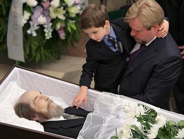 Yermolai Solzhenitsyn, a son of Alexander I. Solzhenitsyn, author of "The Gulag Archipelago," holds his own son so he can see his grandfather. The writer and dissident, 89, who won the Nobel Prize for literature, died Aug. 3. Russian Prime Minister Vladimir Putin said Solzhenitsyn's works should get more emphasis in the schools.