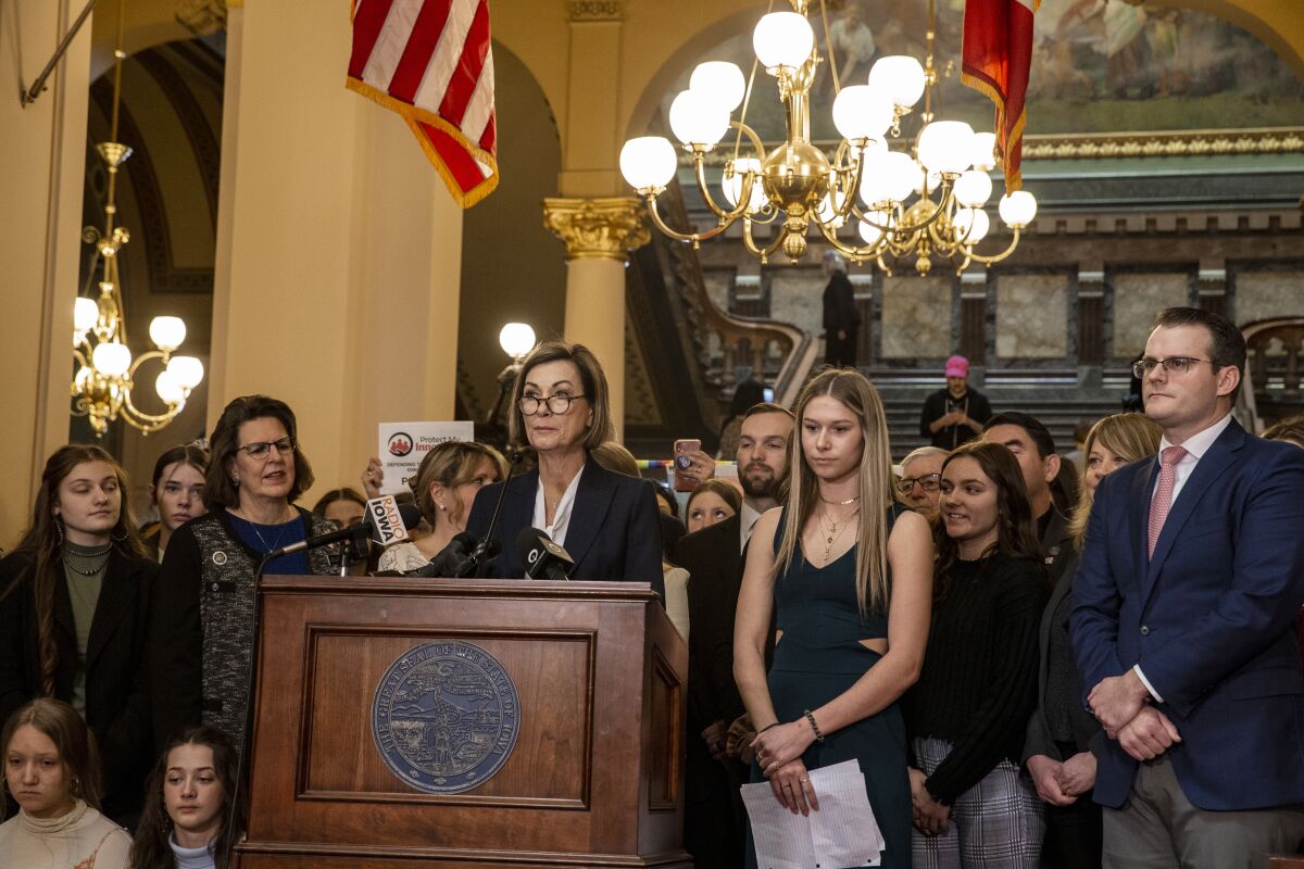 Iowa Governor Kim Reynolds signs a bill that prohibits transgender girls from participating in women's sports at the Iowa State Capitol in Des Moines, Iowa, Thursday, March 3, 2022. he bill prohibits transgender females from participating in girls high school sports and women’s college athletics. (Nick Rohlman/The Gazette via AP)
