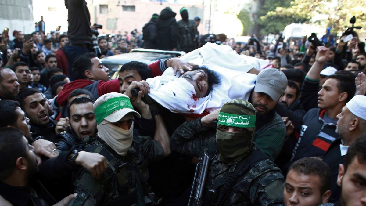 Palestinian mourners carry the body of Hamas member Muhammed Safadi, who was killed in an Israeli missile strike on a Hamas military base, during his funeral in Gaza City on Saturday.