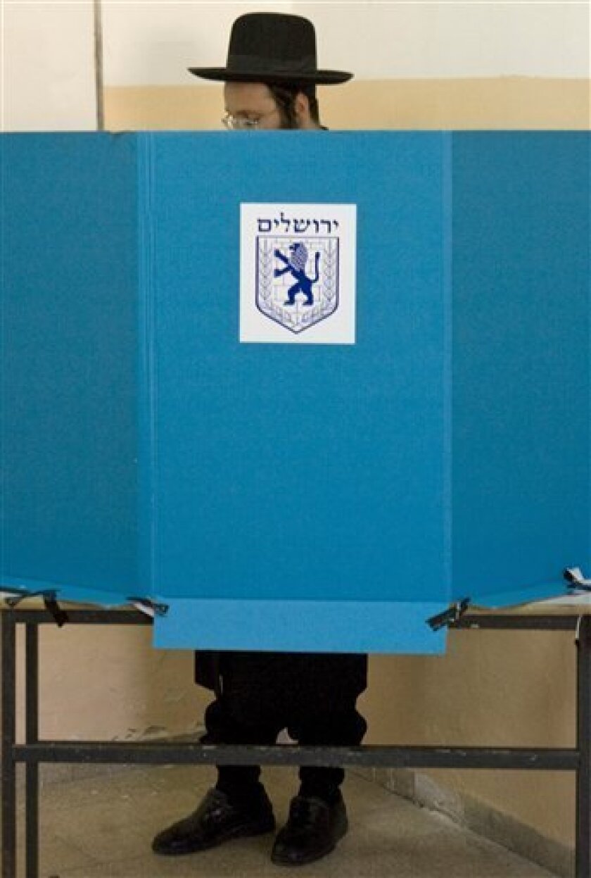 An Ultra-Orthodox Jewish man votes in the Jerusalem mayoral elections in a school in Jerusalem, Tuesday, Nov. 11, 2008. Israelis are heading to the polls to choose mayors of Jerusalem, Tel Aviv and other municipalities across the nation. (AP Photo/Sebastian Scheiner)
