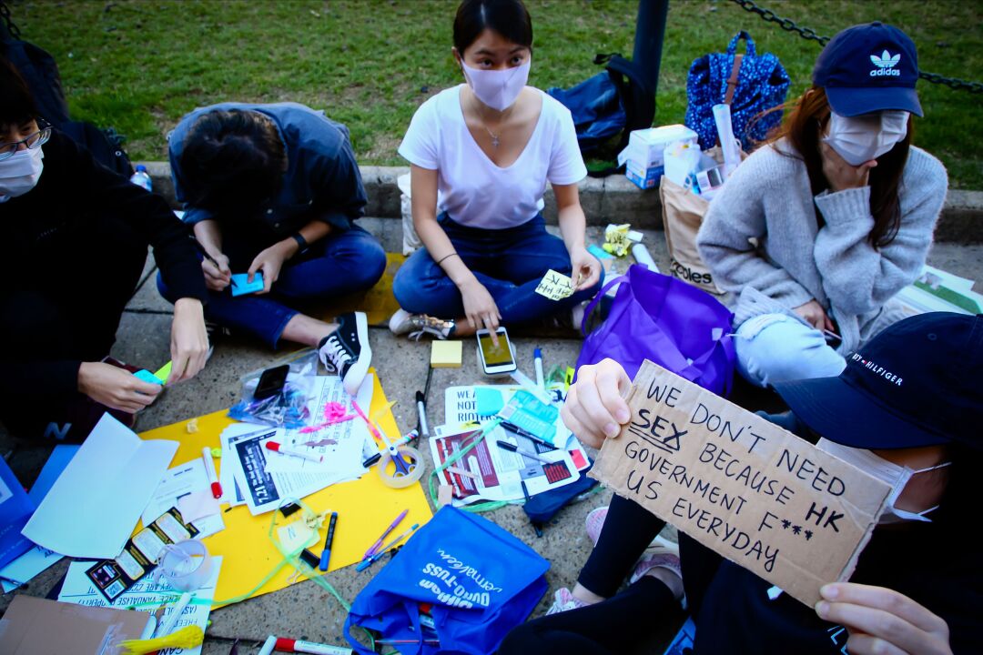 Supporters of the Hong Kong pro-democracy protests writing out sticky notes for a Lennon Wall in 2019.