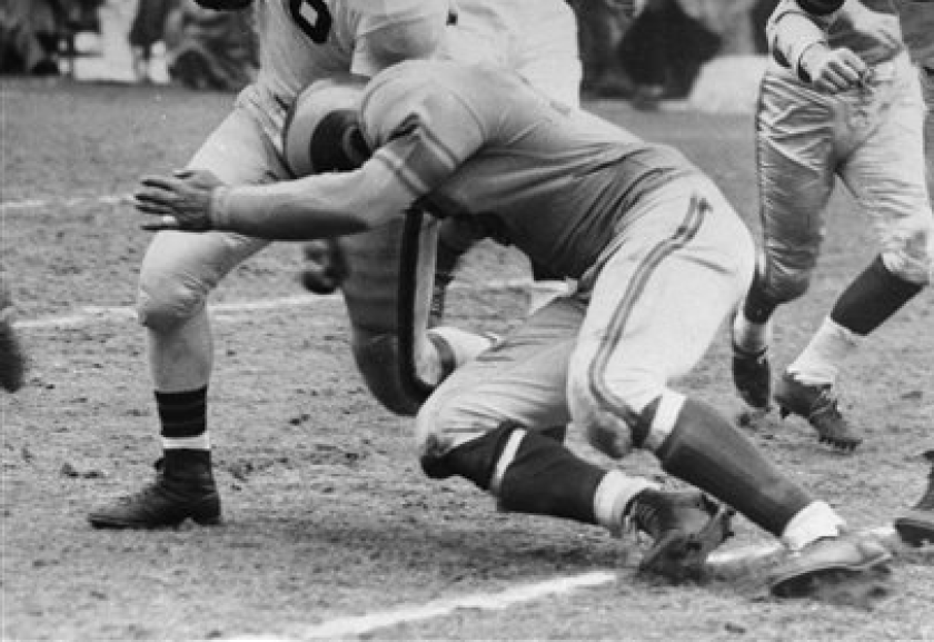 Cleveland fullback Marion Motley is tackled by Rams halfback Paul Younger
