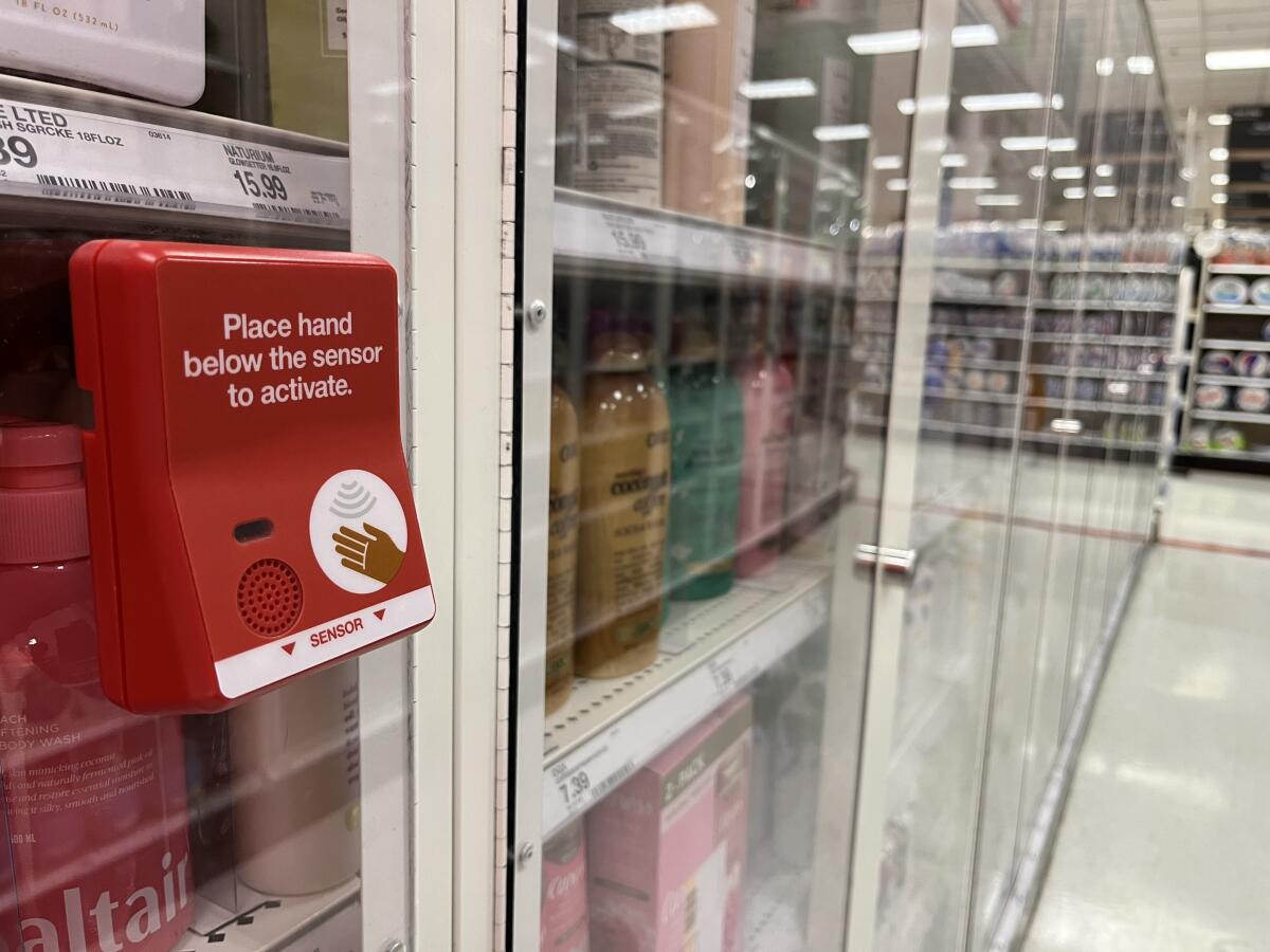 A hand sensor, in red and white, is a security measure at a store.