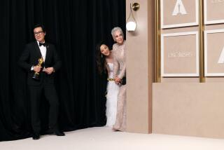 HOLLYWOOD, CA - MARCH 12: Ke Huy Quan, Michelle Yeoh and Jamie Lee Curtis in the Photo Room at the 95th Academy Awards at the Dolby Theatre on March 12, 2023 in Hollywood, California. (Dania Maxwell / Los Angeles Times)