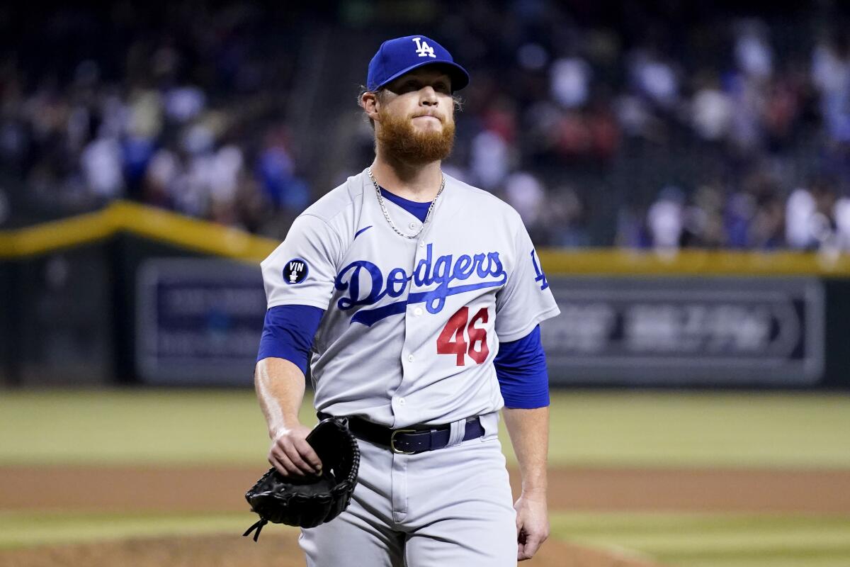Dodgers relief pitcher Craig Kimbrel walks off the field after giving up a game-ending, three-run home run 