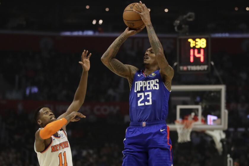 Los Angeles Clippers' Lou Williams (23) shoots over New York Knicks' Frank Ntilikina during the first half of an NBA basketball game Sunday, Jan. 5, 2020, in Los Angeles. (AP Photo/Marcio Jose Sanchez)