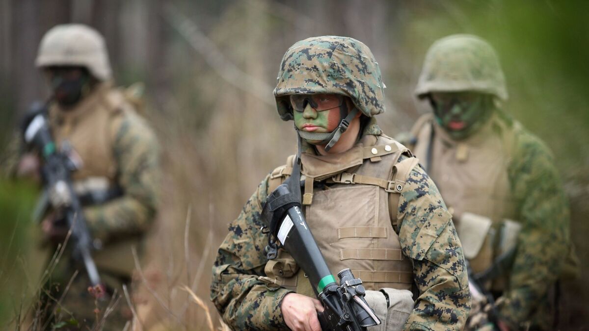 A female private participates in a combat training exercise with other Marines at Camp Lejeune in North Carolina.