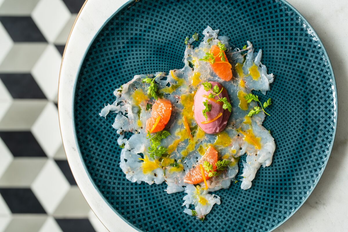 Modern Calabria on a plate: Il Dandy's carpaccio of spot prawns with Tropea red onion sorbetto and citrus slices.