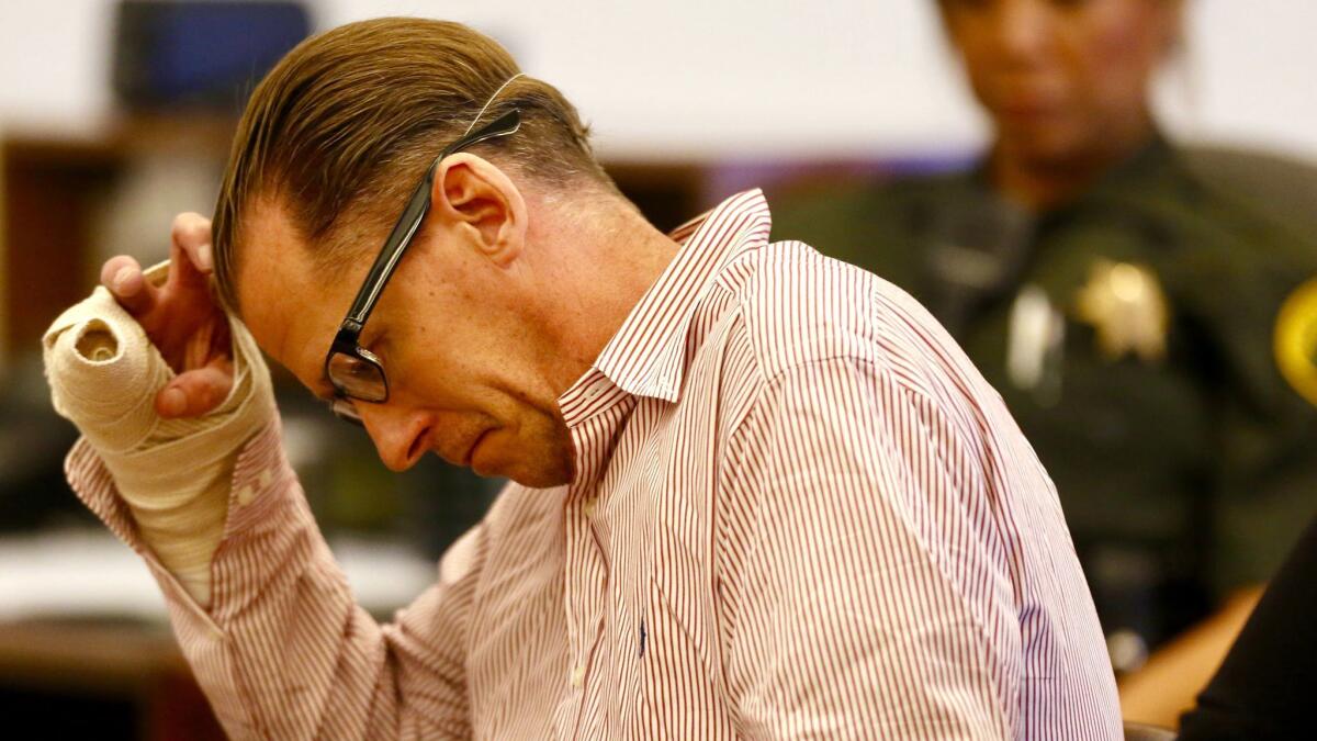 Steven Dean Gordon sits with his head down during sentencing proceedings in a Santa Ana courtroom Friday.