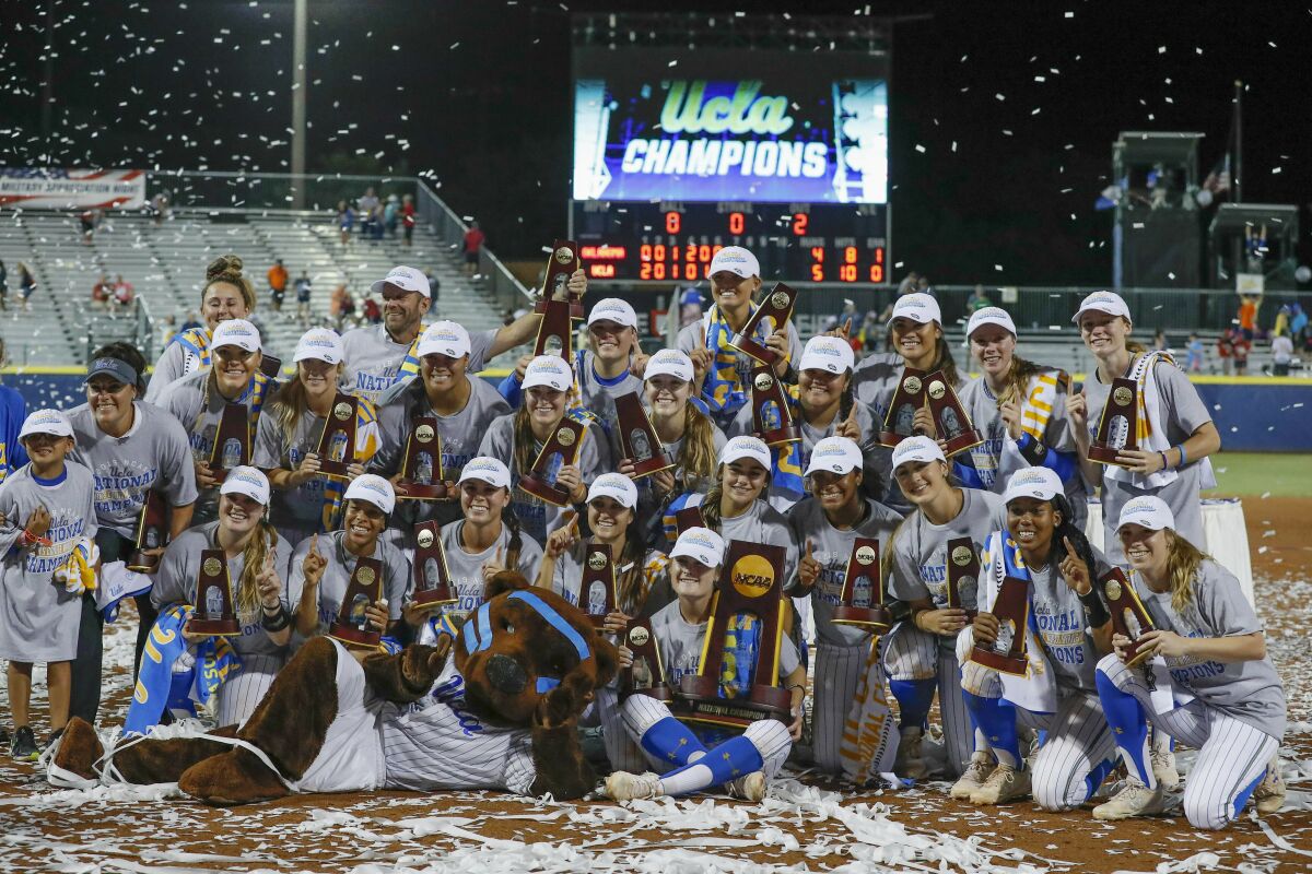 The UCLA softball team poses for photos after defeating Oklahoma in the 2019 Women's College World Series in Oklahoma City.