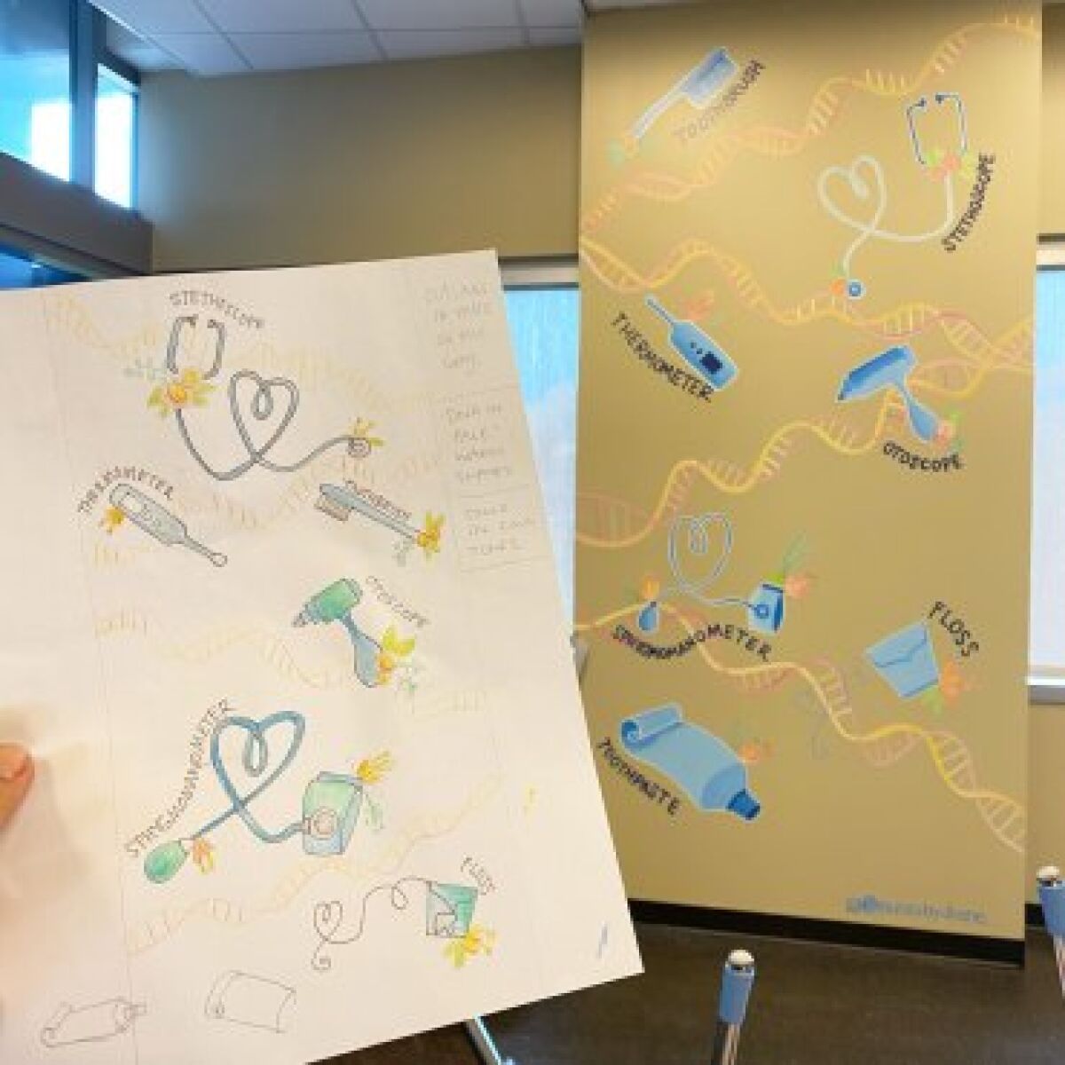 Diane Lehman holds her sketch of the mural for the Father Joe's Villages children's clinic next to the finished product.