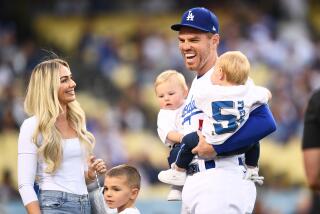 LOS ANGELES, CA - APRIL 18: Los Angeles Dodgers first baseman Freddie Freeman (5) looks on with his wife Chelsea and sons before the MLB game between the Atlanta Braves and the Los Angeles Dodgers on April 18, 2022 at Dodger Stadium in Los Angeles, CA. (Photo by Brian Rothmuller/Icon Sportswire via Getty Images)