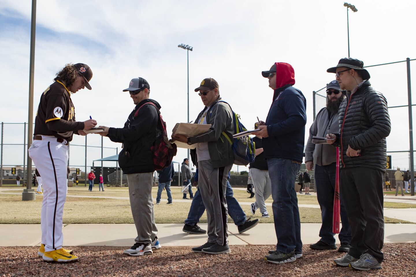 Padres starting pitcher Ryan Weathers (40) signs autographs during a spring training practice at Peoria Sports Complex on Friday.