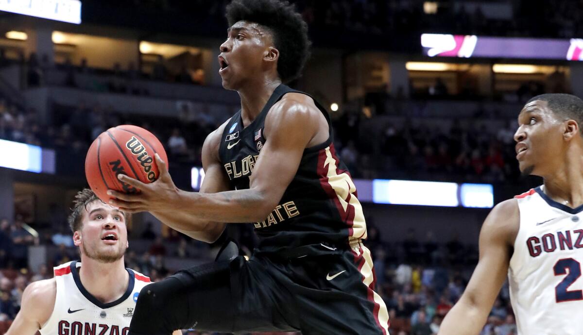 Florida State guard Terance Mann drives to the basket between Gonzaga defenders Cory Kispert, left, and Zach Norvell during an NCAA tournament game.