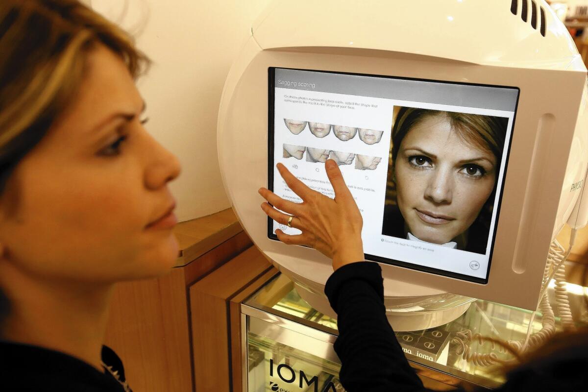 AT Ioma at Saks Fifth Avenue in Beverly Hills, Shari Arbab, left and on screen, learns her skin score.