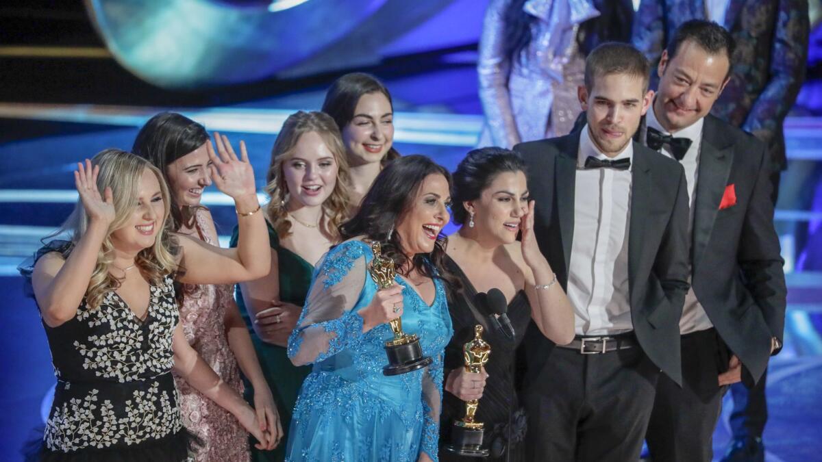 Melissa Berton, center left, and Rayka Zehtabchi, center right, accept the Short Film (Live Action) award for Period. End Of Sentence. during the telecast of the 91st Academy Awards.