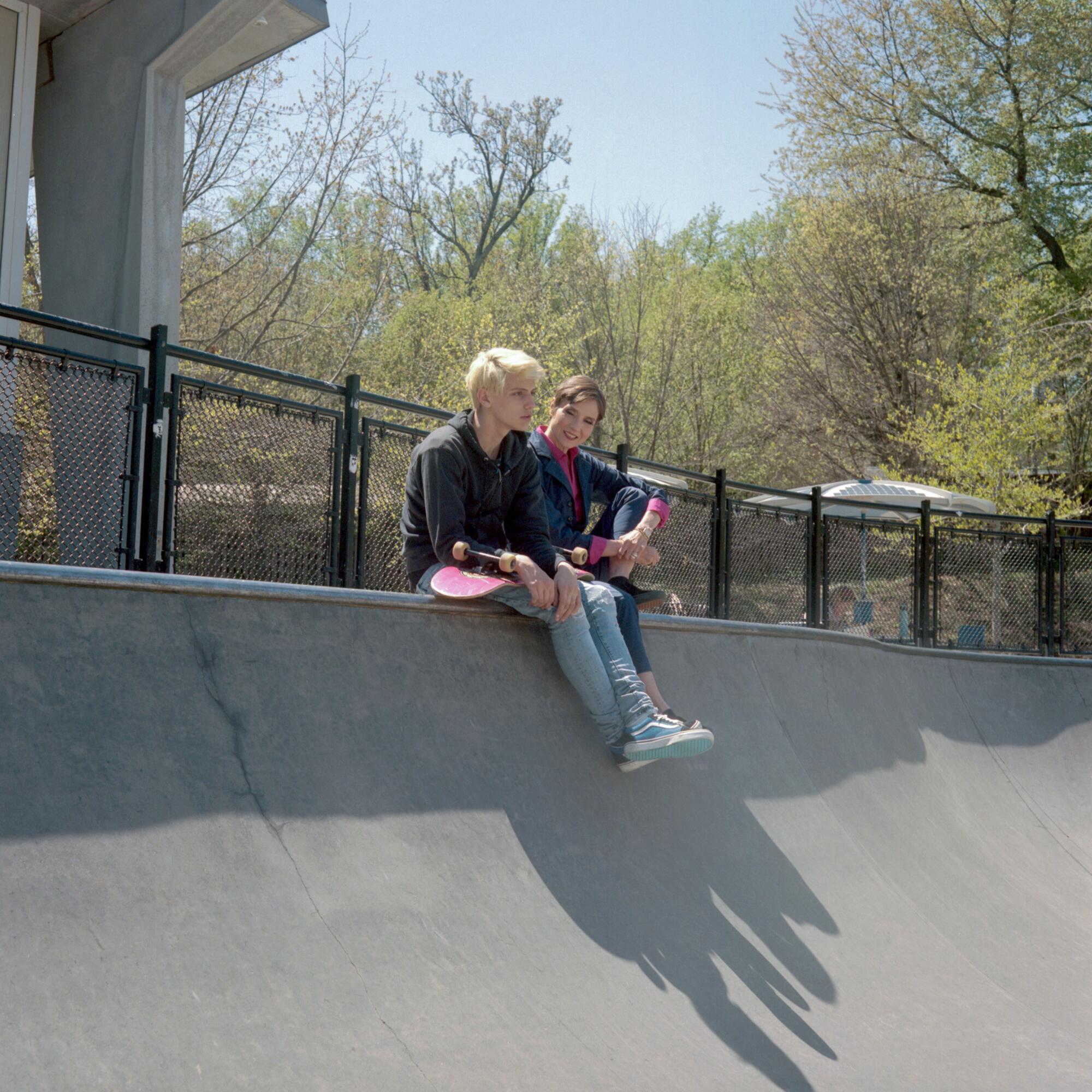 Catherine Herridge sits with her son Peter after a skateboarding session at the Powhatan Springs Skatepark in Arlington, Va.