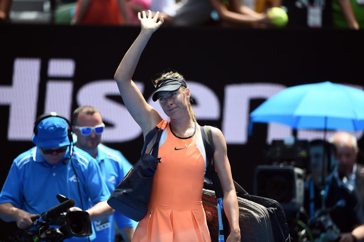 Maria Sharapova of Russia gestures to the crowd after losing to Serena Williams in a quarterfinal match of the Australian Open on Jan. 26.