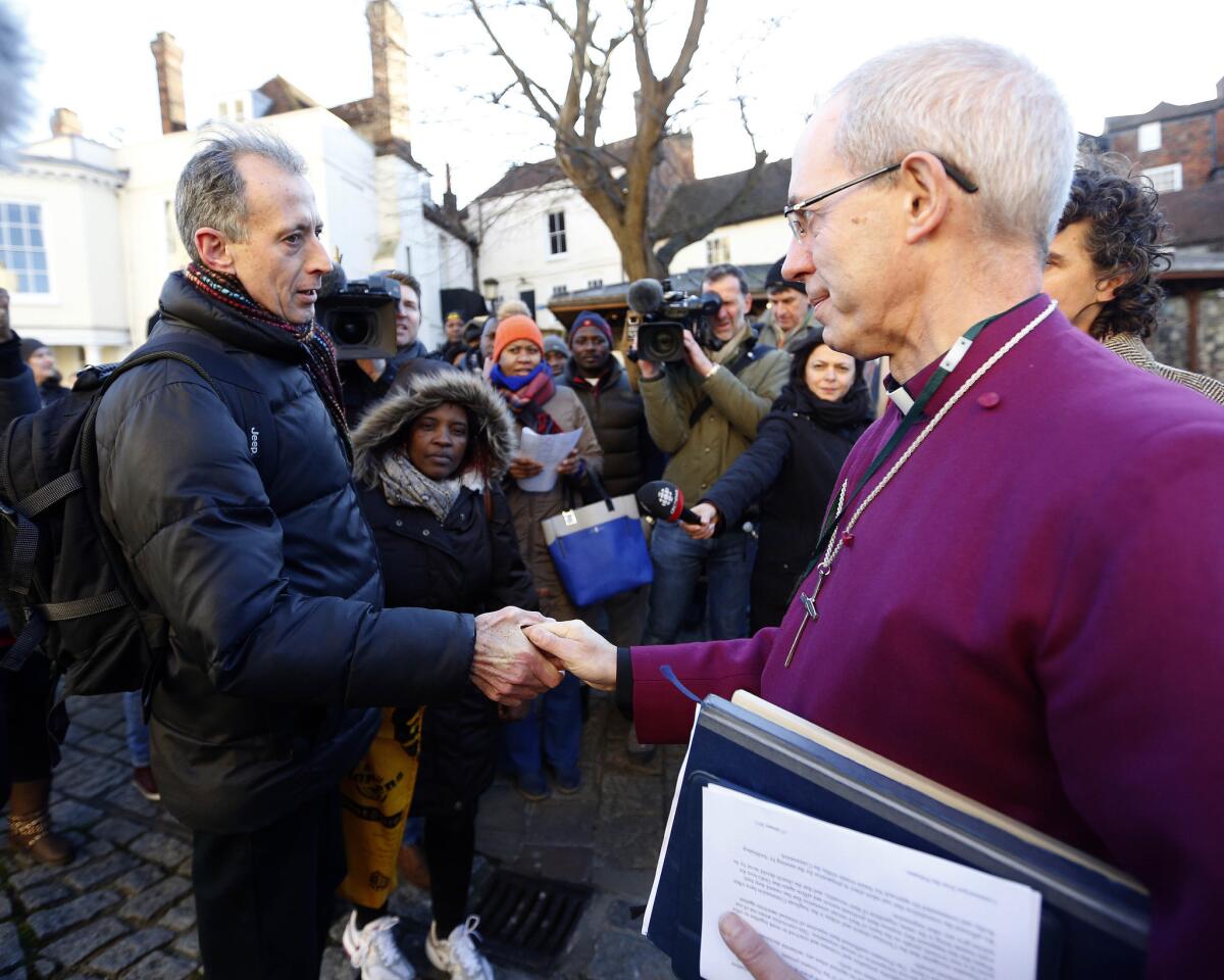 Archbishop of Canterbury Justin Welby, right, and human rights activist Peter Tatchell greet before a news conference in Canterbury, England, on Friday.