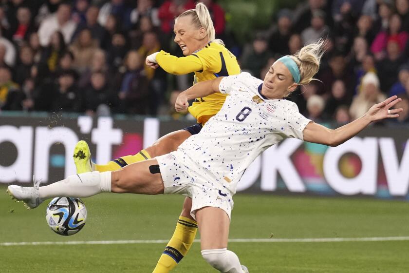 Sweden's Stina Blackstenius and United States' Julie Ertz, right, battle for the ball.