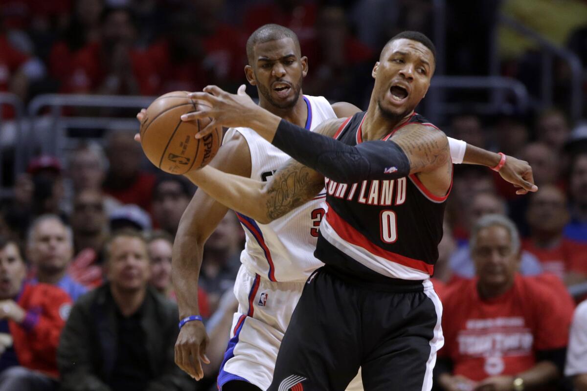 Clippers guard Chris Paul collides with Trail Blazers guard Damian Lillard during Game 2.