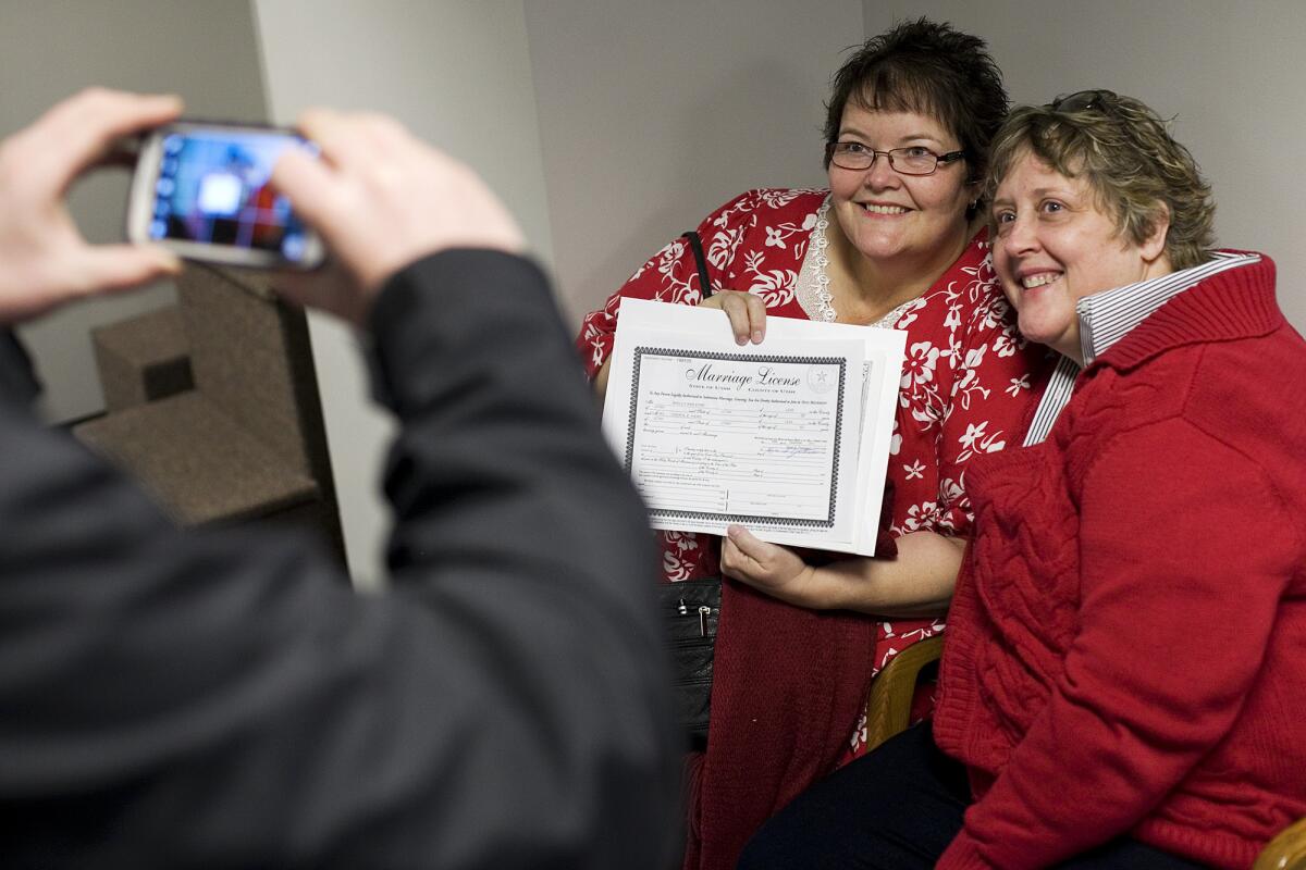 Cheryl Haws, right, and her partner Shelly Eyre have their photograph taken after receiving their marriage license at the Utah County clerk's office in Provo, Utah.