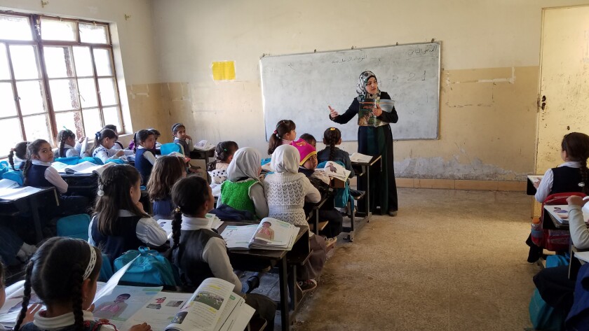 Rashan Shokr teaches science to Iraqi second-graders at Al Akhaa school on Mosul's east side.