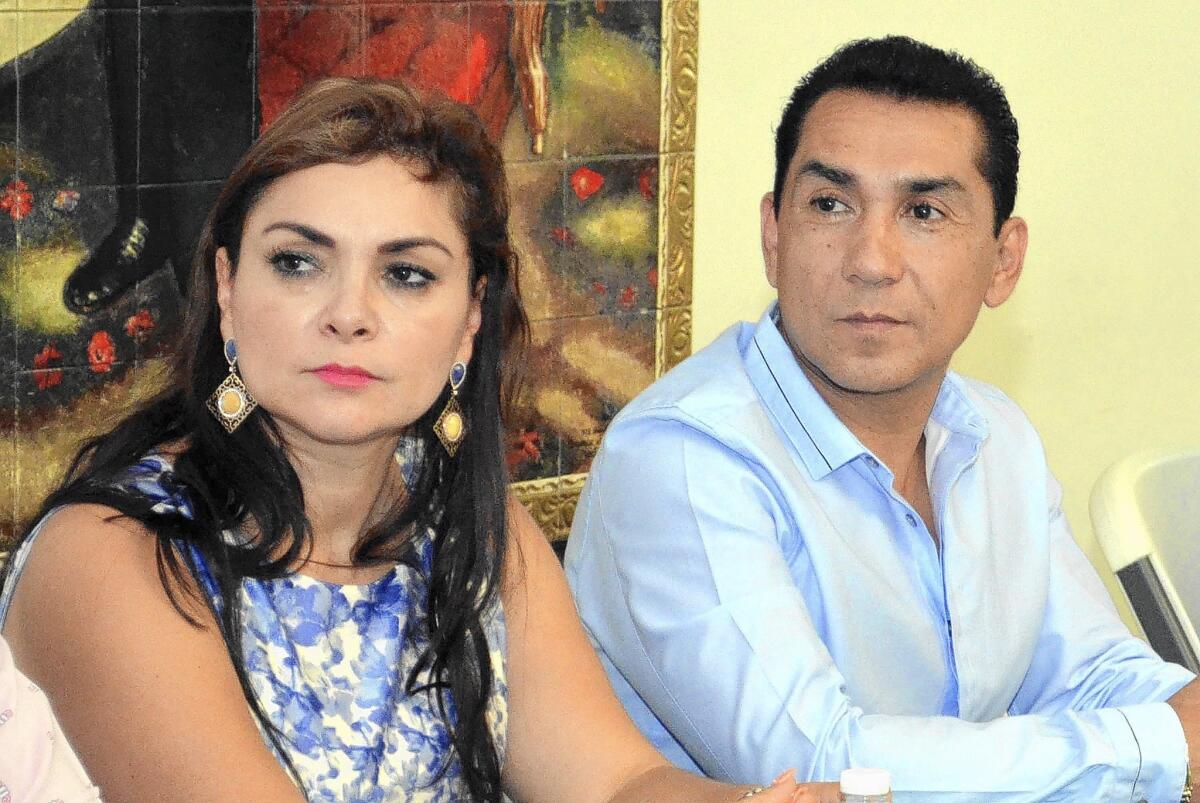 Iguala Mayor Jose Luis Abarca and his wife, Maria de los Angeles Pineda, meet with Guerrero state officials in Chilpancingo, Mexico, in May. He is wanted for questioning in the student disappearances.