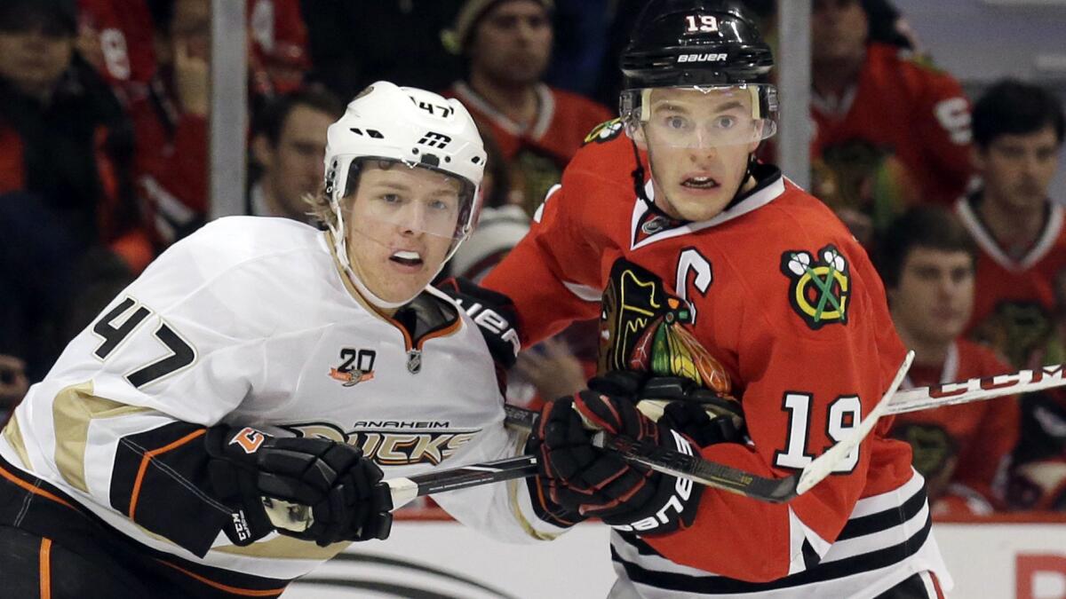 Ducks forward Hampus Lindholm, left, and Chicago Blackhawks captain Jonathan Toews battle for position during a game in January 2014.