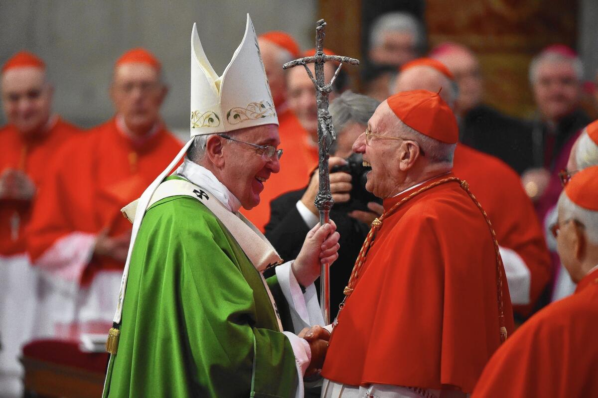 Pope Francis, left, greets French Cardinal Roger Etchegaray at the end of the Mass at St. Peter's Basilica at the Vatican.