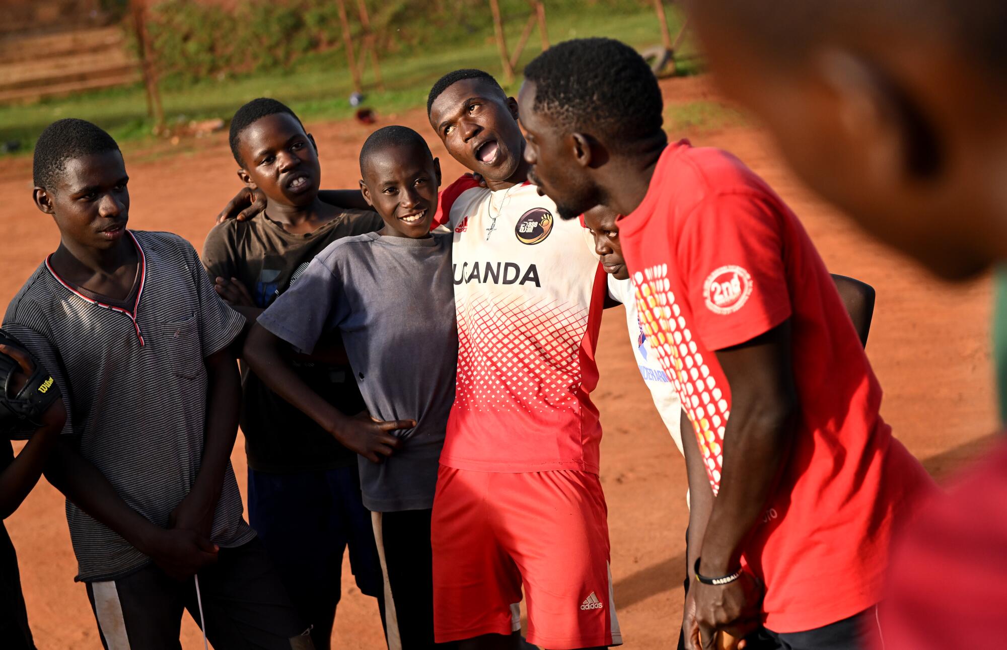 Dennis Kazumba, third from right, shares a laugh with other players after practice.