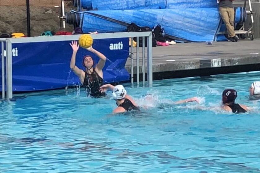 Rylie Hage makes a save in goal for the Point Loma High girls water polo team.
