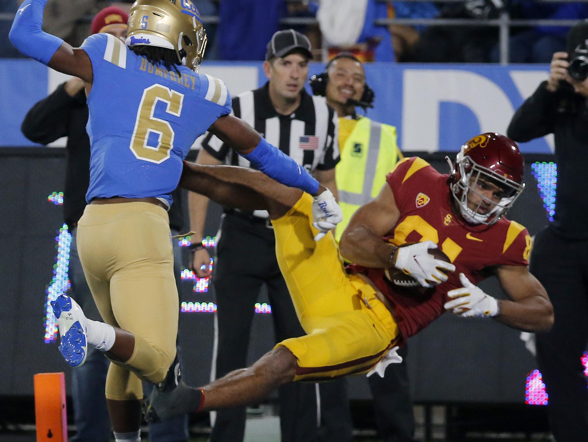 USC wide receiver Kyle Ford hauls in a touchdown pass in front of UCLA cornerback John Humphrey.