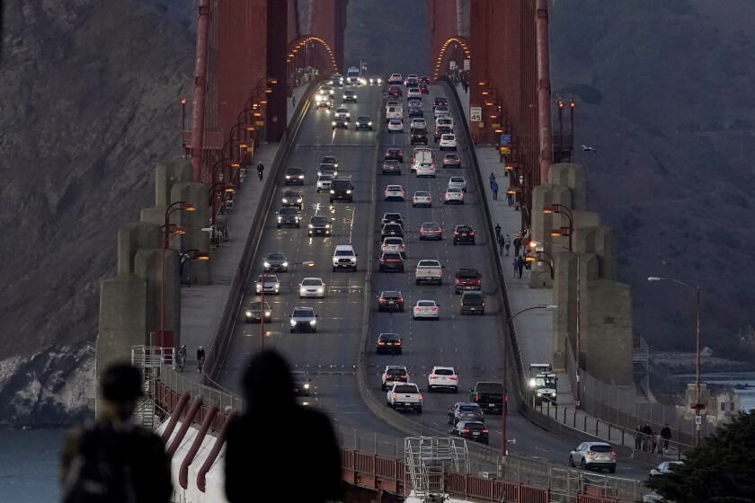 FILE - In this Nov. 12, 2020, file photo, traffic moves on the Golden Gate Bridge in San Francisco. The San Francisco Chronicle reported Saturday, May 15, 2021, that the iconic span started emanating a loud hum following a retrofit last year of the sidewalk safety railing on its western side. Crews replaced some 12,000 wide slats with narrower ones, to give the bridge a slimmer profile and make it safer in high winds. (AP Photo/Jeff Chiu, File)