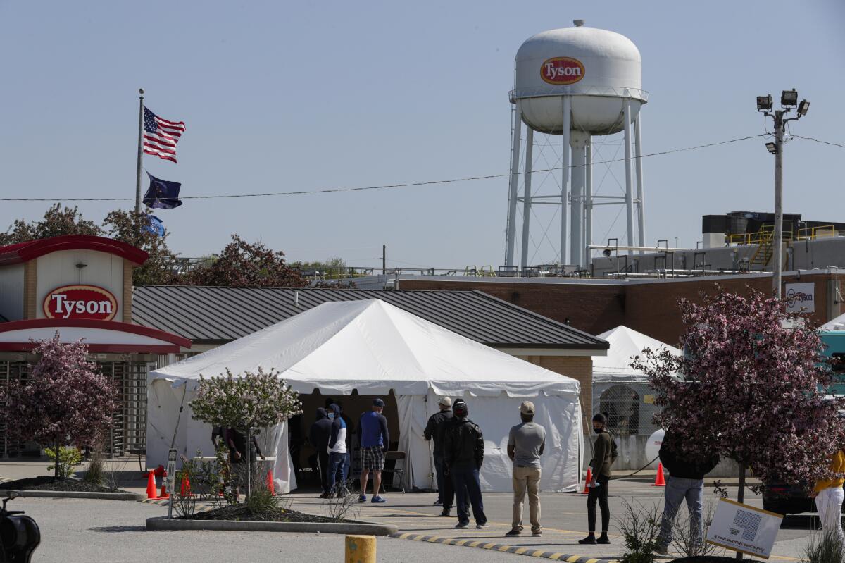 Workers lined up to enter pork-processing plant