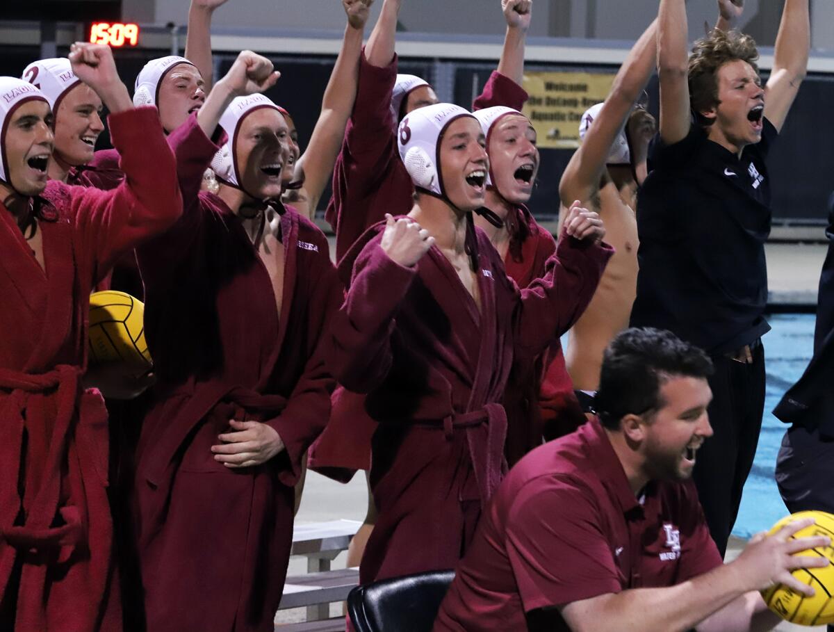 Laguna Beach's boys' water polo team celebrates after winning at Foothill on Wednesday in a Division 1 semifinal match.
