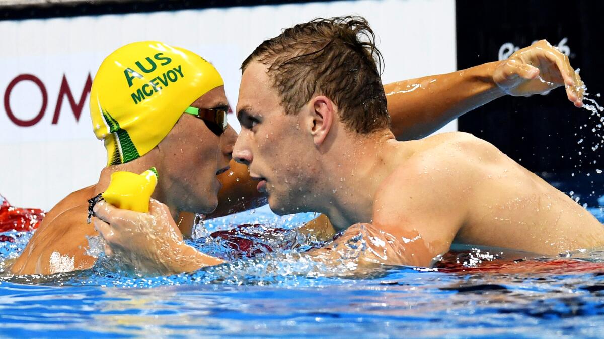 Australia's Kyle Chalmers, right, is congratulated by countryman Cameron McEvoy after winning the men's 100-meter freestyle final Wednesday.