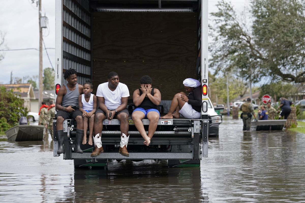Hurricane Ida evacuees in truck surrounded by floodwaters