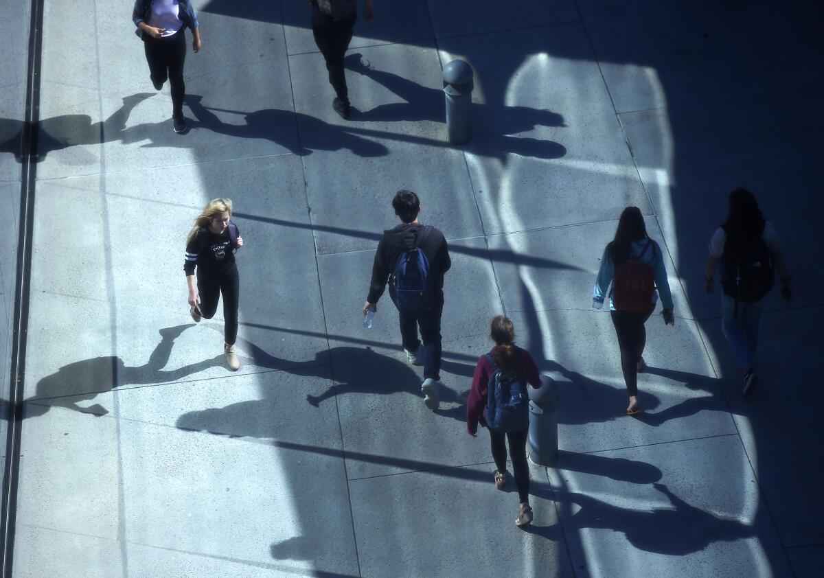 UC San Diego students walk to Geisel Library at the school on April 24, 2019.